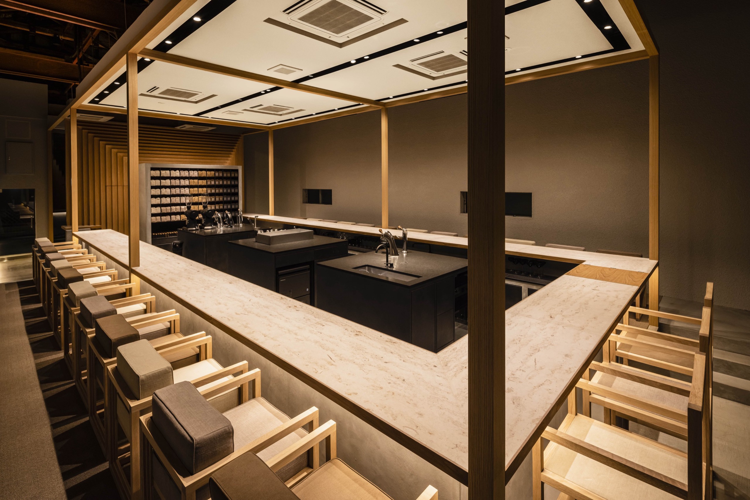 An old warehouse turned coffee theater · A timber and warehouse district in Kiyosumi-Shirakawa, converted. The old shell stays as it was, and a new timber structure sits inside it, setting old against new. ⓒ KOFFEE MAMEYA / 14sd Fourteen Stones Design