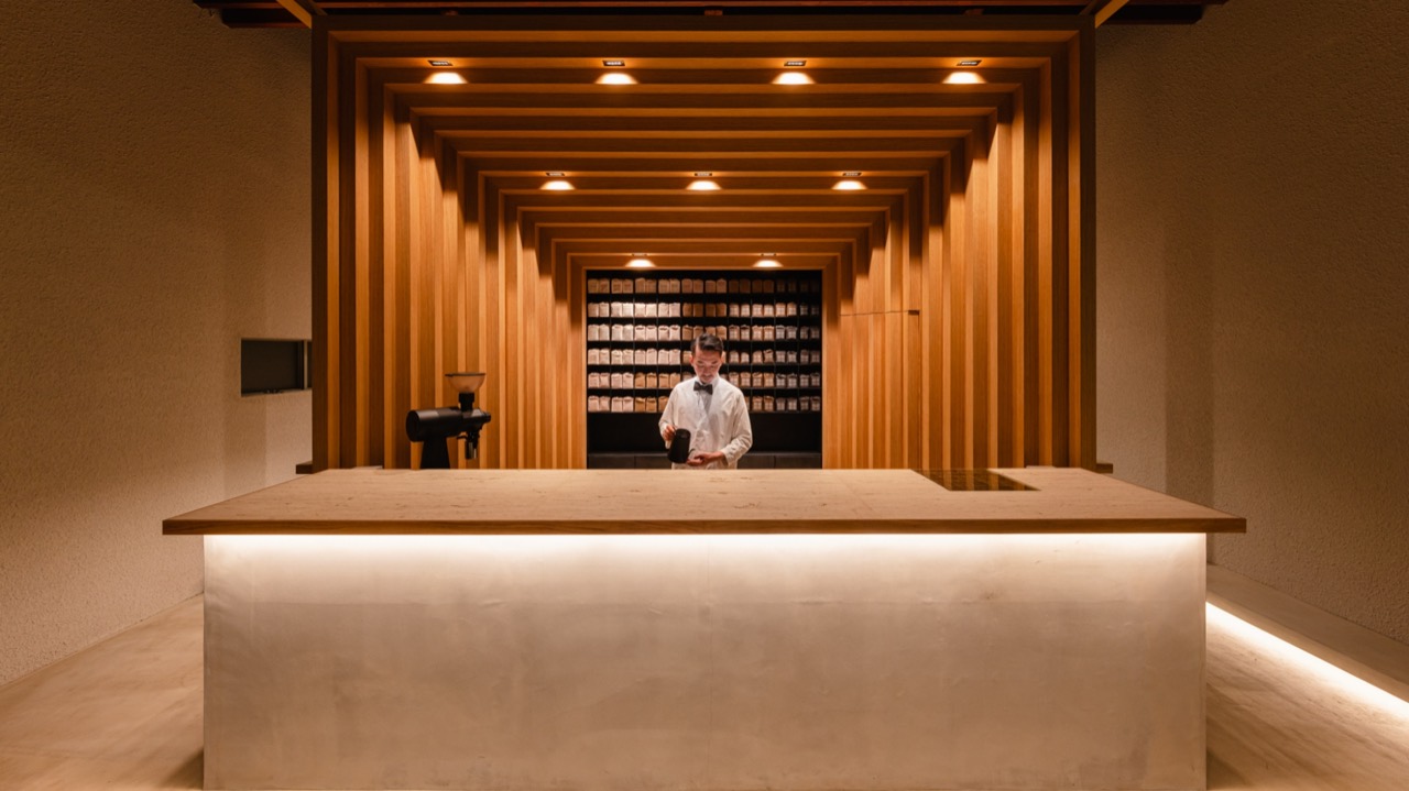 Packaging blown up to architecture · The interlocking white oak frame that dominates the entrance moves the bean packaging design to architectural scale. Instead of hanging a logo, they made the skeleton of the building the brand. ⓒ KOFFEE MAMEYA / 14sd