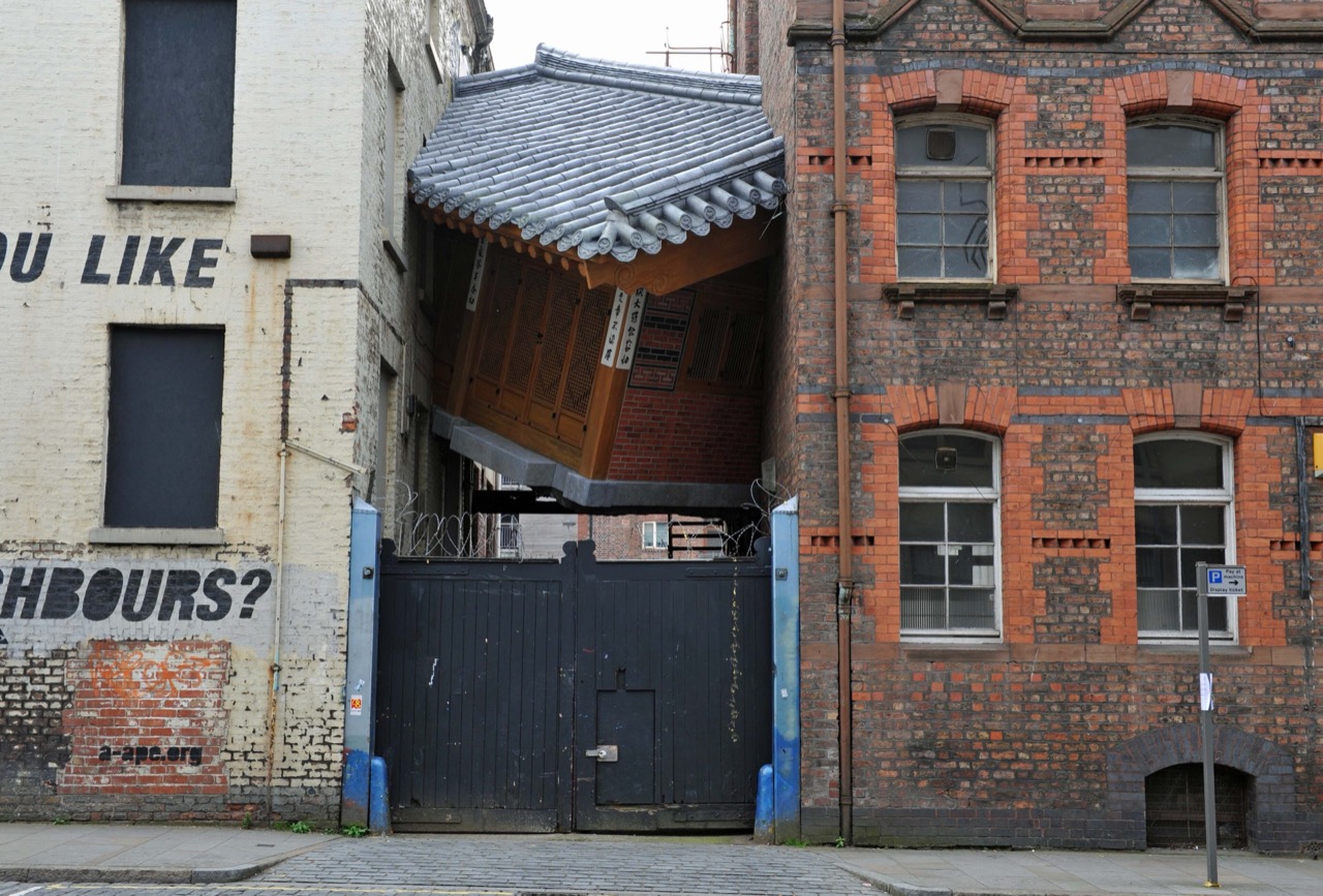 건물 사이에 낀 한옥 · 2010년 리버풀 비엔날레(Liverpool Biennial)에 낸 〈Bridging Home〉. 영국 벽돌 건물 틈에 한옥을 밀어 넣었다. ⓒJulian Stallabrass · CC BY 2.0