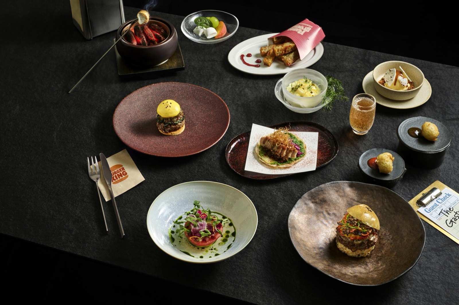 The 89,000 won table · The Whopper's components, taken apart and spread across plates. The guest check at bottom right reads The Gastro. ©BKR