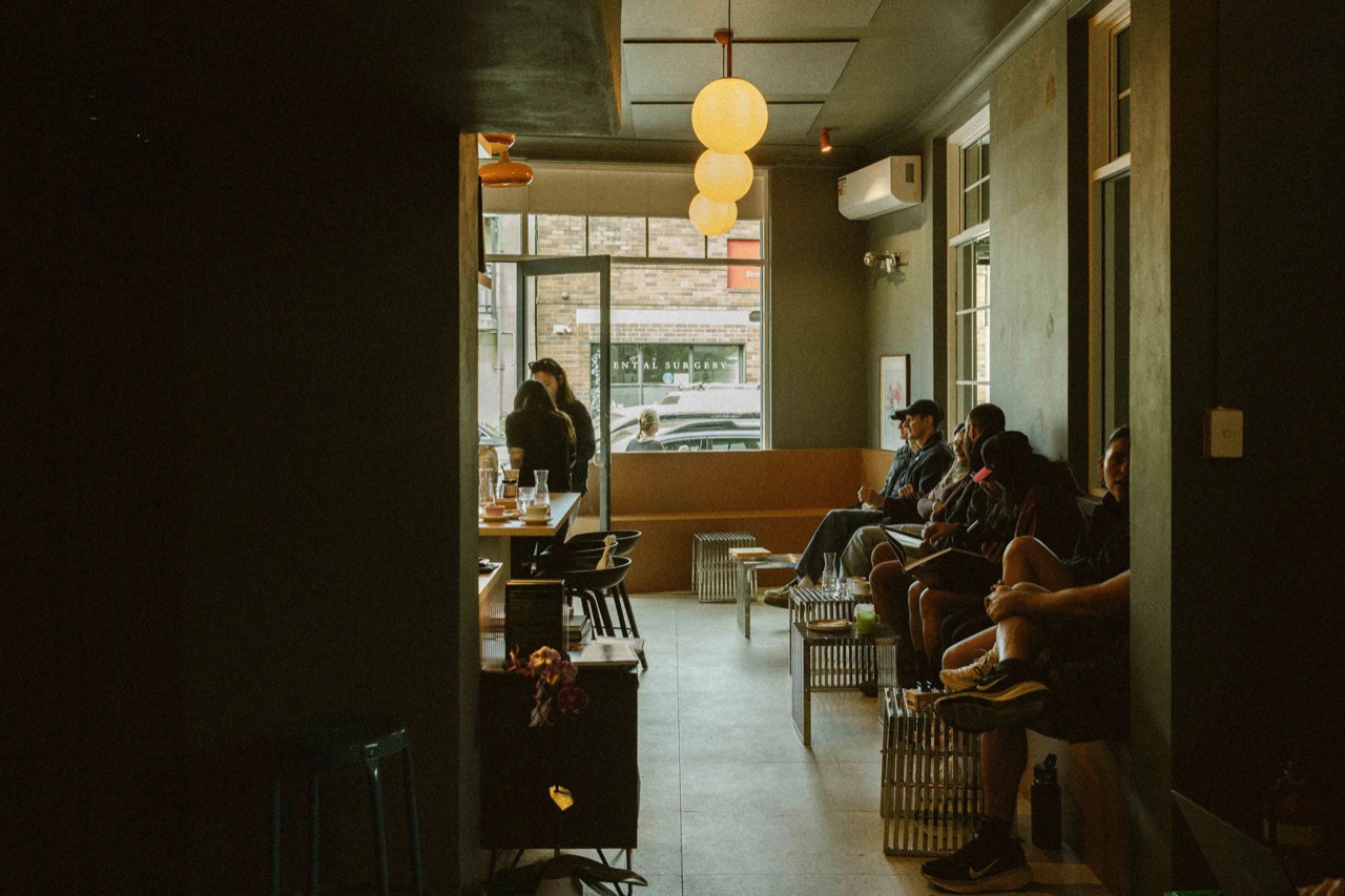Darker toward the back · The silver metal side tables in front of the banquette are knee high. The light is gathered at the street end. ©Yusuke Oba · Broadsheet