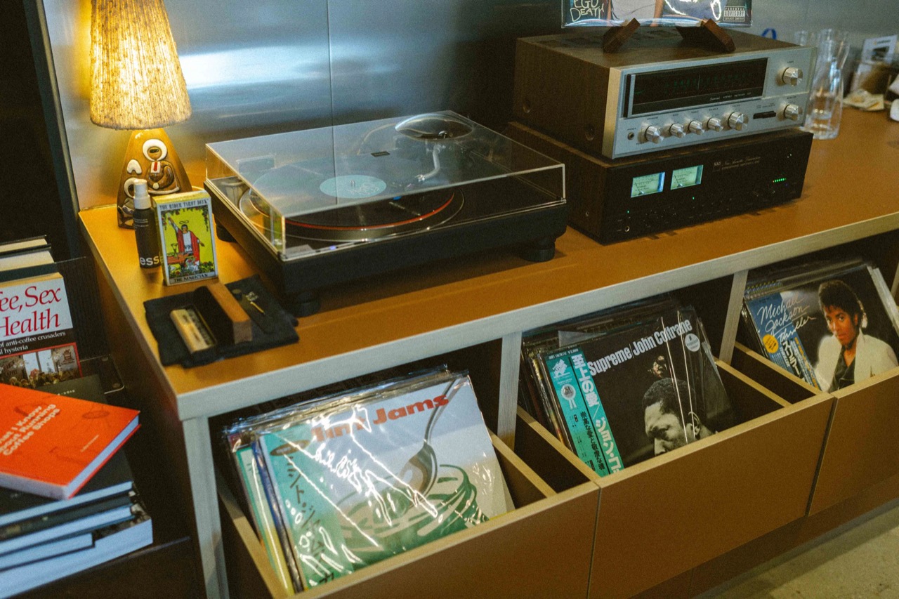 The counter doubles as a rack · A Love Supreme by John Coltrane on a Japanese pressing and Thriller by Michael Jackson sit in the record crate. The pile on the left is books. ©Yusuke Oba · Broadsheet