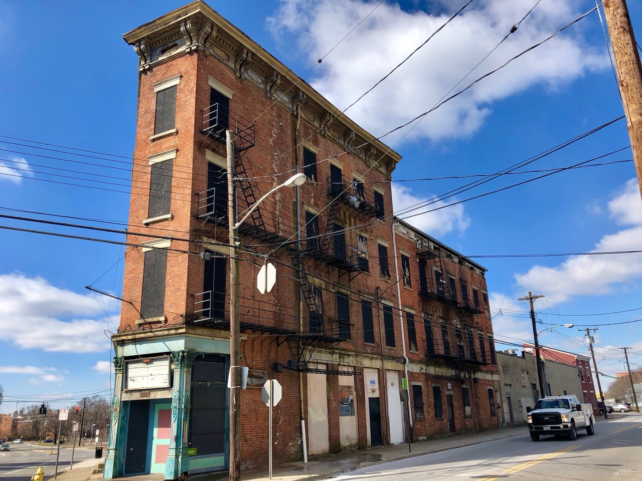 The other side of the same street · An empty 19th century brick building on McMicken Avenue. Blocks like this one are still here. ©Warren LeMay · Wikimedia Commons (CC0)