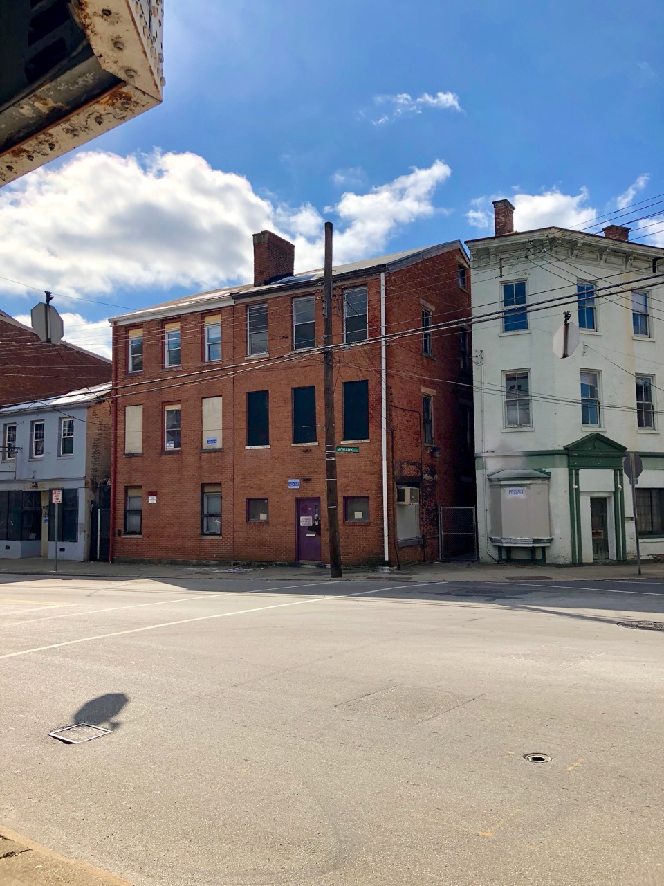 A corner past the terminus · An intersection on McMicken Avenue. The block with the cafe sits on a street like this. ©Warren LeMay · Wikimedia Commons (CC0)