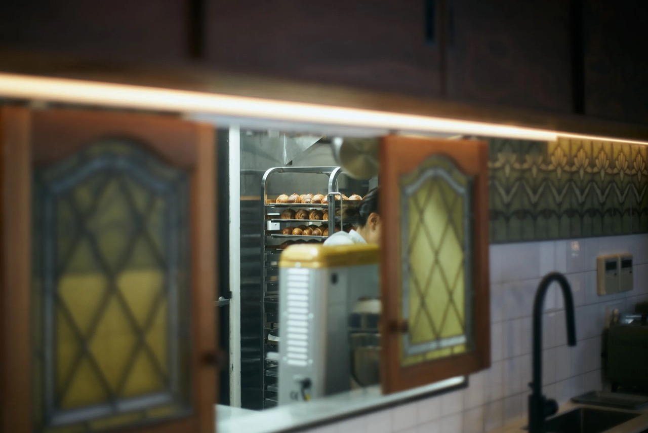 The kitchen window · Through the coloured glass: the oven and bread racks. ⓒBroadsheet