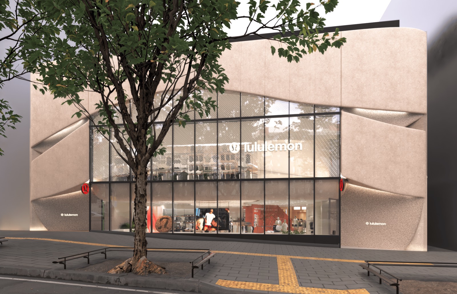 Folded stone, two floors of glass · Beige stone panels fold like a wave around two floors of glazing. Red logos sit in the folds on both sides. ⓒlululemon