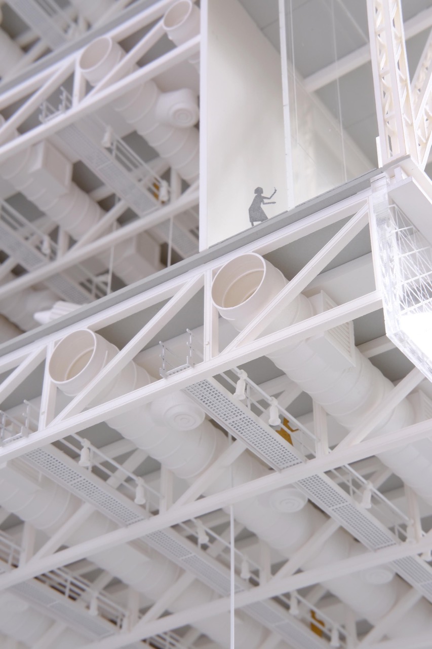 Sectional model at 1:100 · How the lattice wraps the exhibition volumes reads at a glance. ©Kinkfab